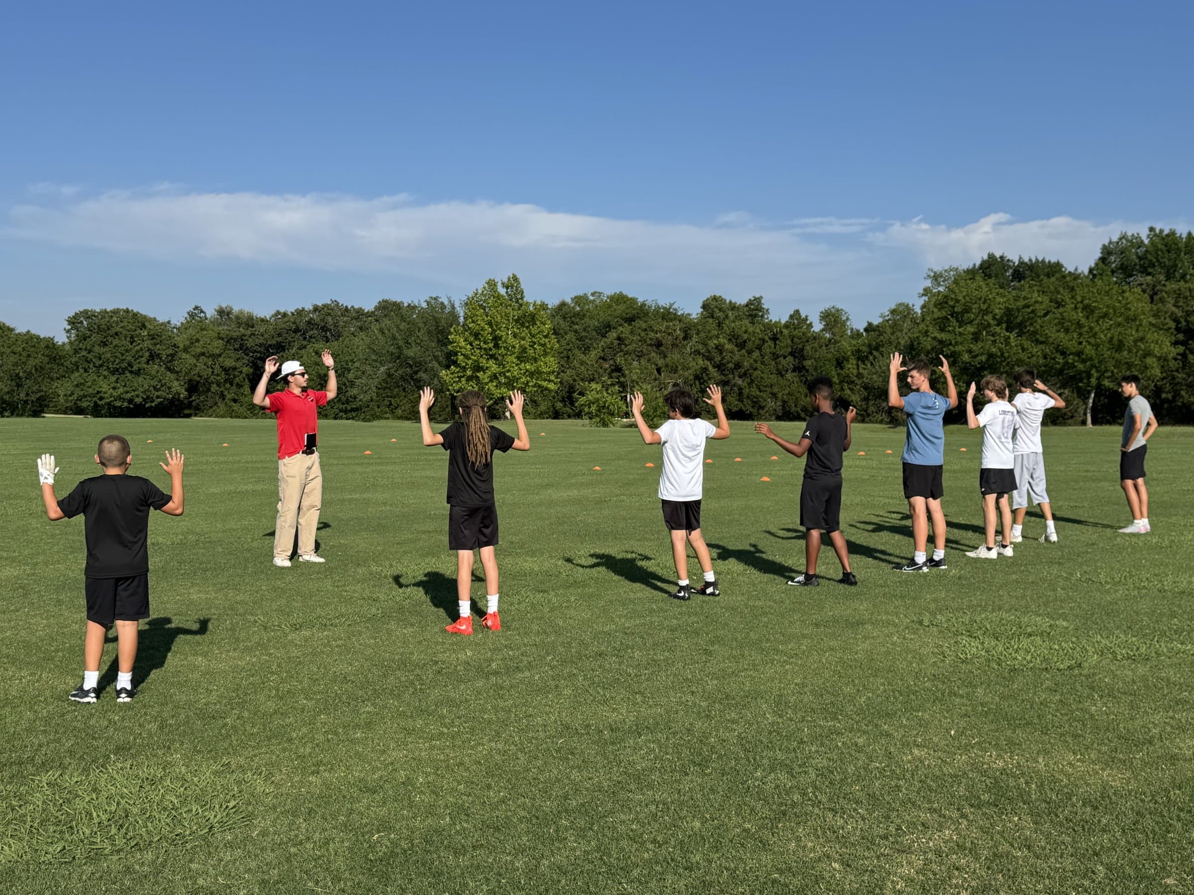 Coaching quarterback fundamentals at a CADEX camp