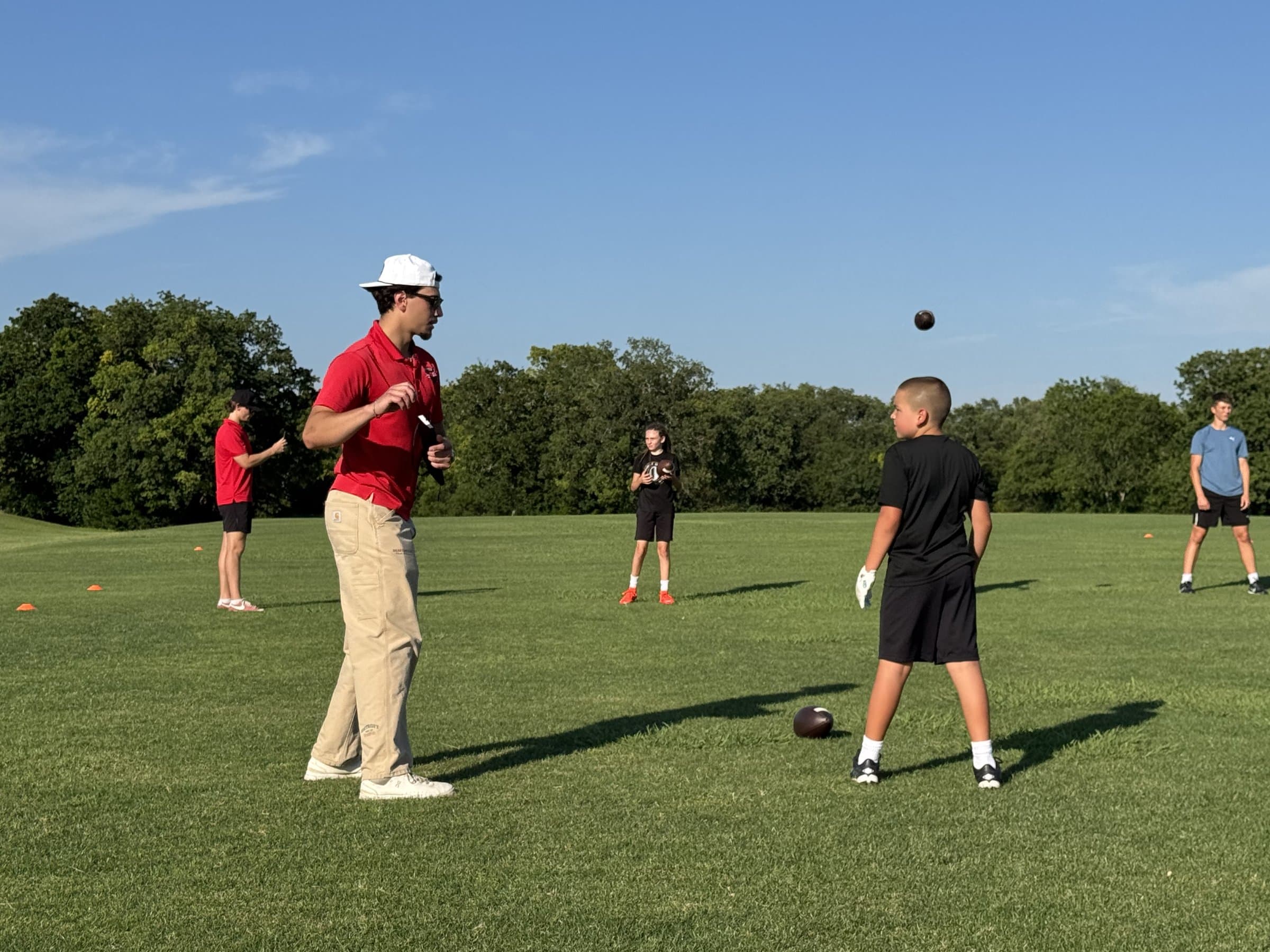 Brett Skinner works with athletes on the field